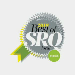 A silver and gold award badge labeled "2019 Best of SRQ local" with a green ribbon and a green circle that says "Winner.
